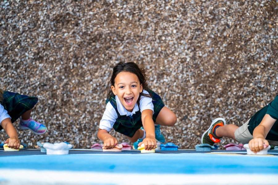 preschool student rock climbing wall